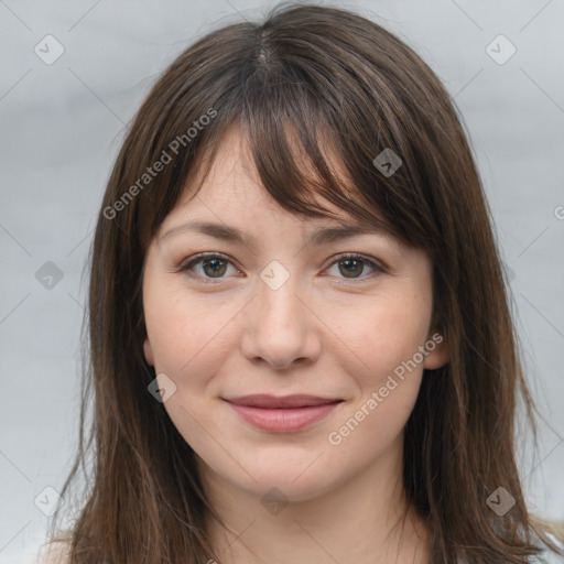 Joyful white young-adult female with long  brown hair and grey eyes