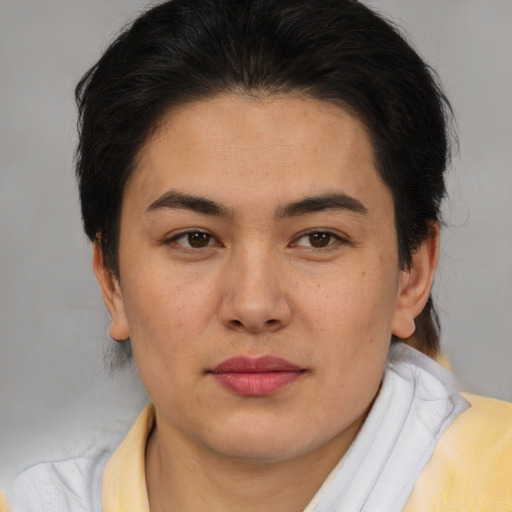 Joyful latino young-adult female with short  brown hair and brown eyes