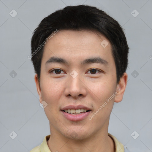 Joyful asian young-adult male with short  black hair and brown eyes