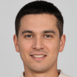 Joyful white young-adult male with short  brown hair and brown eyes