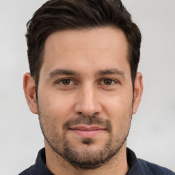 Joyful white adult male with short  brown hair and brown eyes