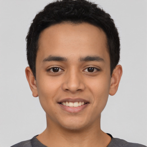 Joyful latino young-adult male with short  black hair and brown eyes