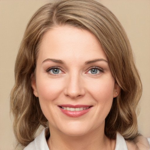 Joyful white young-adult female with medium  brown hair and green eyes