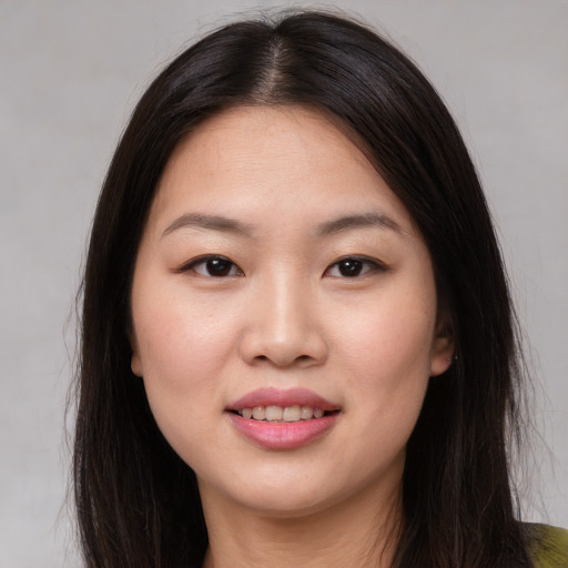 Joyful asian young-adult female with long  brown hair and brown eyes