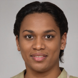 Joyful latino young-adult female with short  black hair and brown eyes