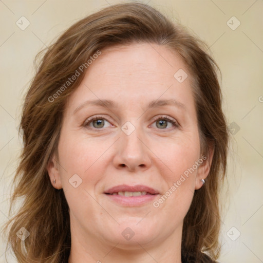 Joyful white adult female with medium  brown hair and green eyes