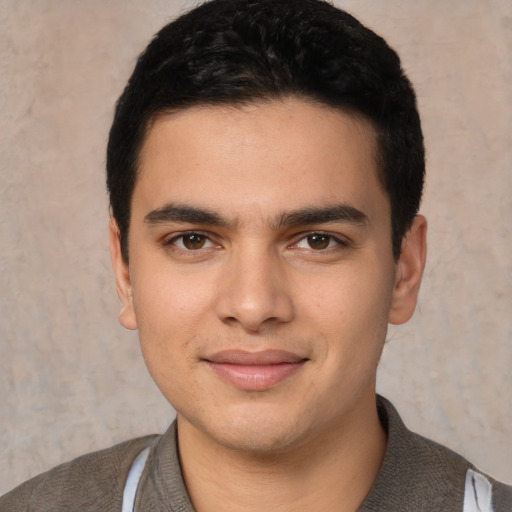 Joyful white young-adult male with short  black hair and brown eyes