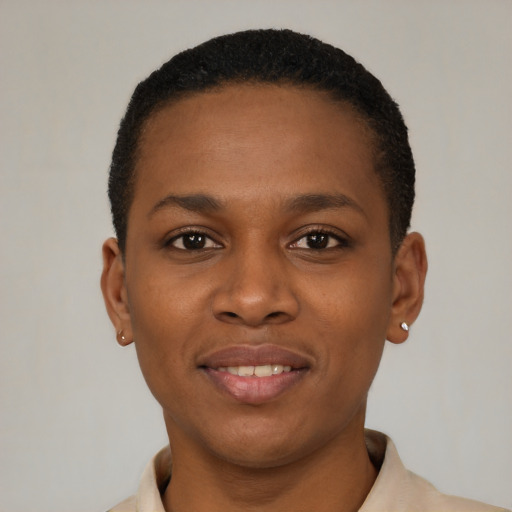 Joyful black young-adult female with short  black hair and brown eyes