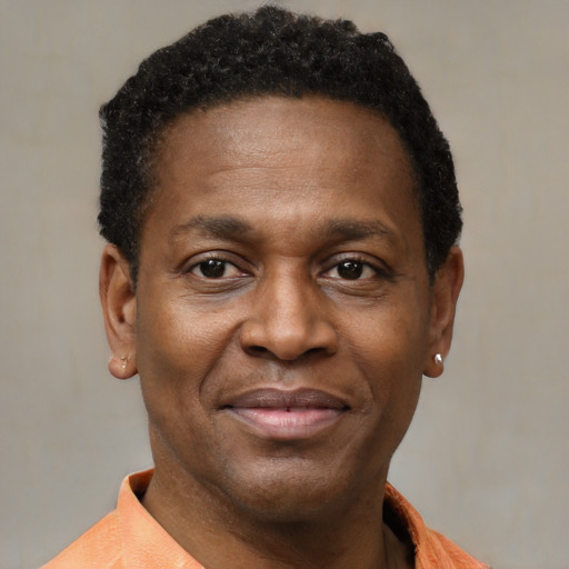 Joyful black adult male with short  brown hair and brown eyes