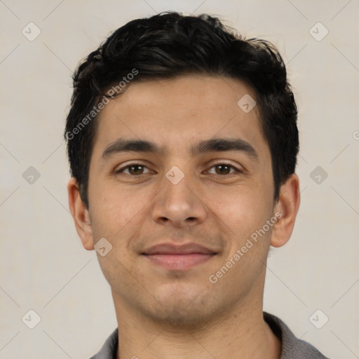 Joyful latino young-adult male with short  black hair and brown eyes