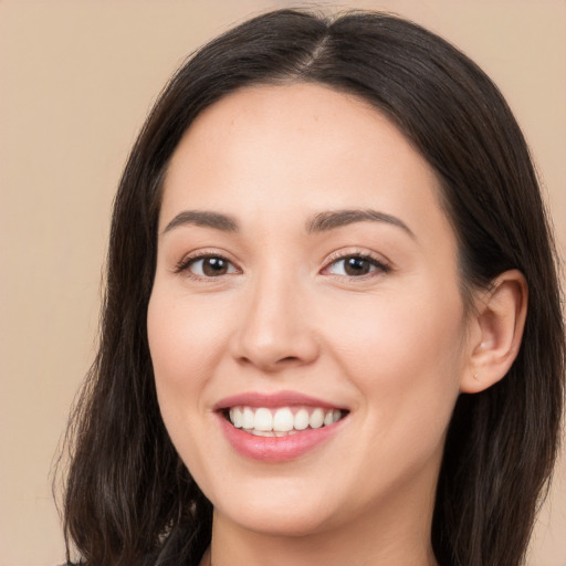 Joyful white young-adult female with long  brown hair and brown eyes