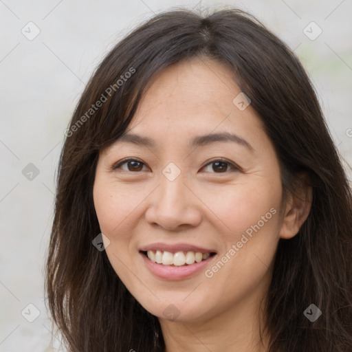 Joyful white young-adult female with long  brown hair and brown eyes