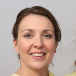 Joyful white adult female with medium  brown hair and brown eyes