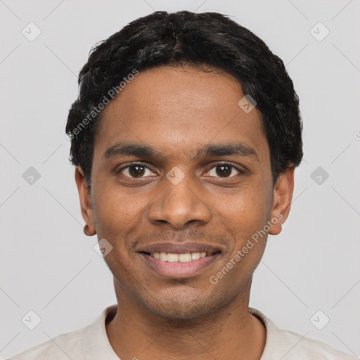 Joyful black young-adult male with short  black hair and brown eyes