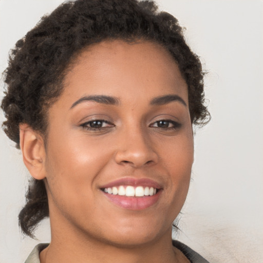 Joyful latino young-adult female with short  brown hair and brown eyes