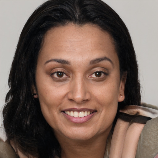 Joyful latino young-adult female with medium  brown hair and brown eyes