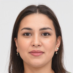 Joyful white young-adult female with long  brown hair and brown eyes