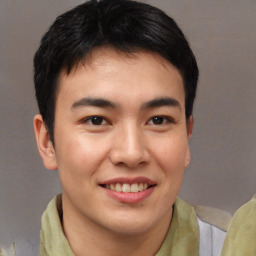 Joyful asian young-adult male with short  brown hair and brown eyes