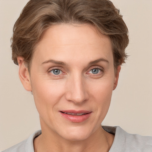 Joyful white adult female with short  brown hair and grey eyes