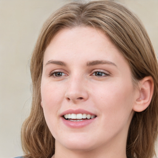 Joyful white young-adult female with medium  brown hair and blue eyes