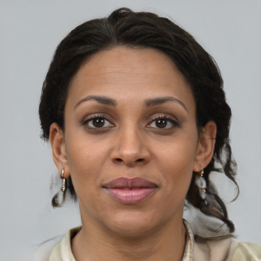 Joyful black adult female with medium  brown hair and brown eyes