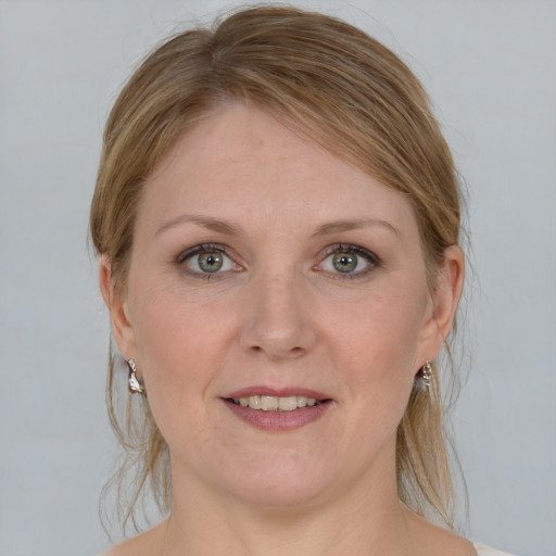 Joyful white adult female with medium  brown hair and blue eyes