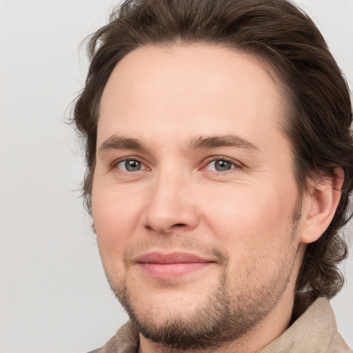 Joyful white young-adult male with medium  brown hair and brown eyes