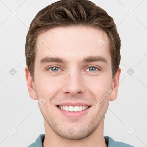 Joyful white young-adult male with short  brown hair and grey eyes