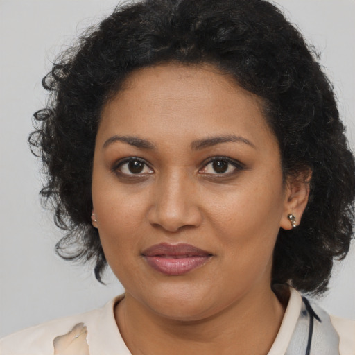 Joyful black young-adult female with medium  brown hair and brown eyes