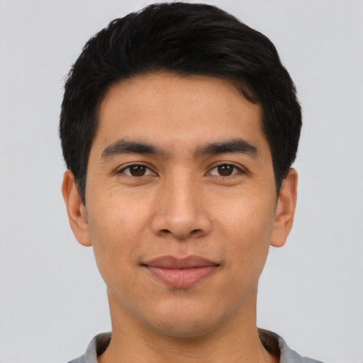 Joyful asian young-adult male with short  black hair and brown eyes