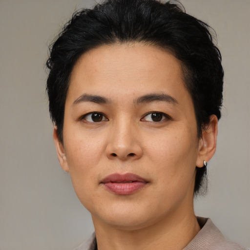 Joyful asian young-adult female with short  black hair and brown eyes