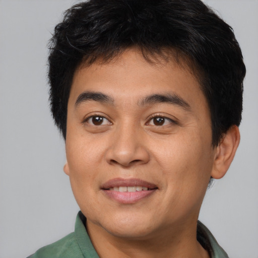 Joyful asian young-adult male with short  brown hair and brown eyes