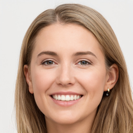 Joyful white young-adult female with long  brown hair and grey eyes