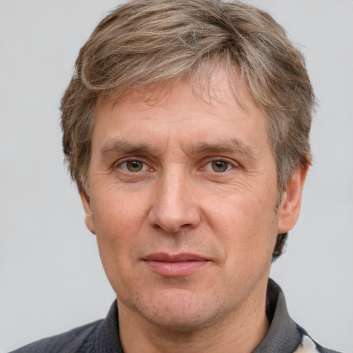 Joyful white adult male with short  brown hair and grey eyes