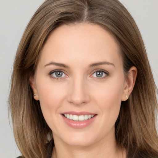 Joyful white young-adult female with long  brown hair and grey eyes