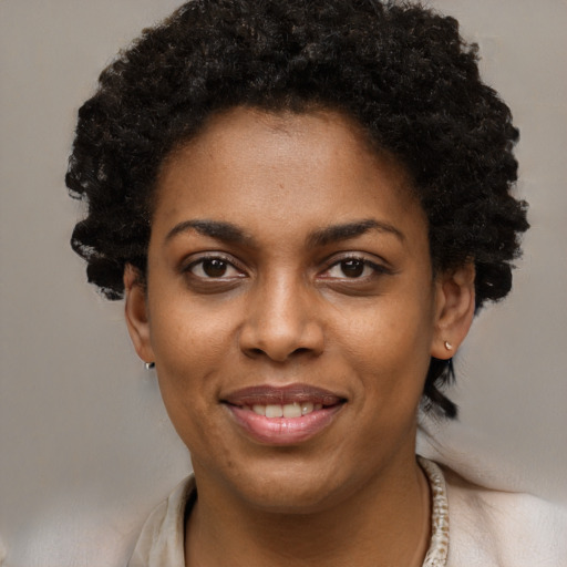 Joyful black young-adult female with short  brown hair and brown eyes