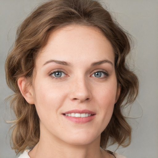 Joyful white young-adult female with medium  brown hair and blue eyes