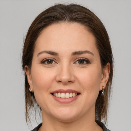 Joyful white young-adult female with medium  brown hair and brown eyes