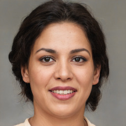 Joyful latino young-adult female with medium  brown hair and brown eyes