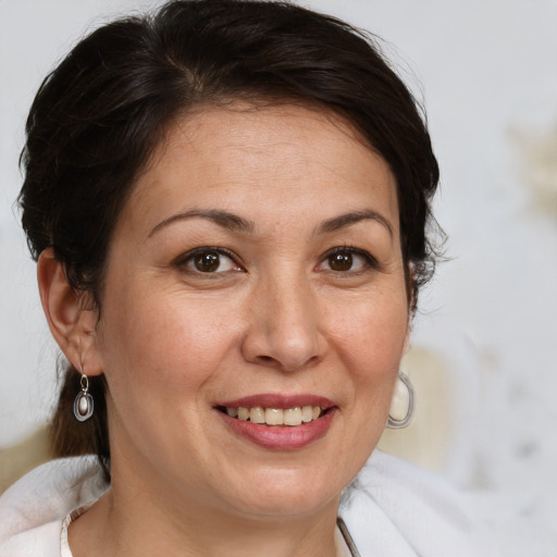 Joyful white adult female with medium  brown hair and brown eyes