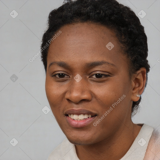 Joyful black young-adult female with short  black hair and brown eyes