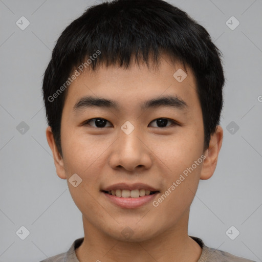 Joyful asian young-adult male with short  black hair and brown eyes