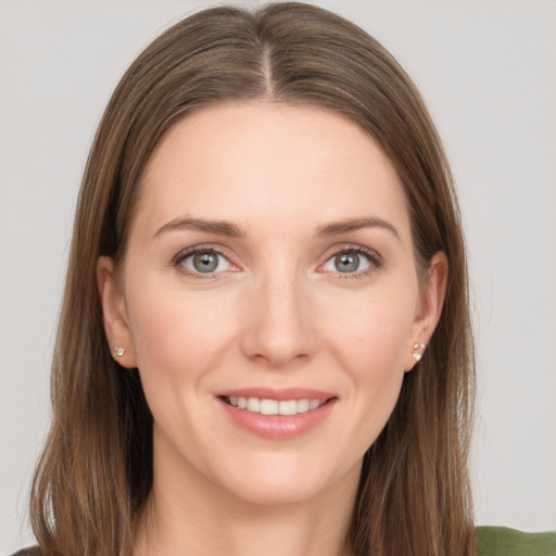 Joyful white young-adult female with long  brown hair and grey eyes