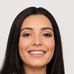 Joyful latino young-adult female with long  black hair and brown eyes