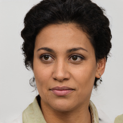 Joyful latino young-adult female with short  brown hair and brown eyes