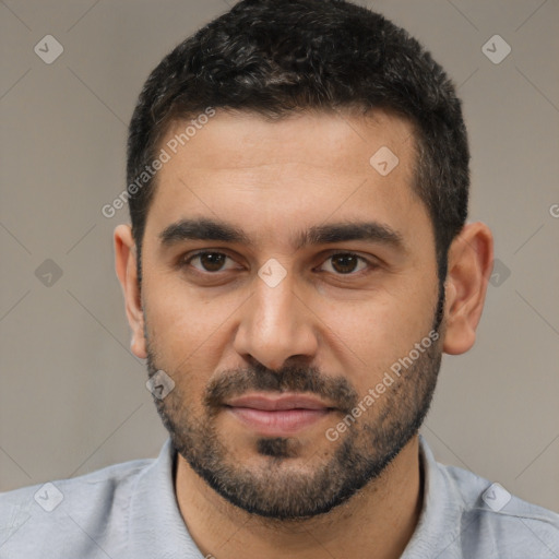 Joyful white young-adult male with short  black hair and brown eyes