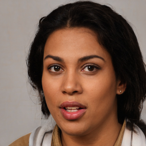 Joyful latino young-adult female with medium  black hair and brown eyes