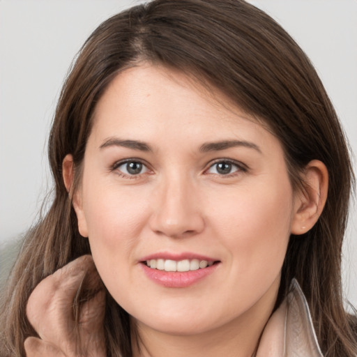 Joyful white young-adult female with long  brown hair and brown eyes