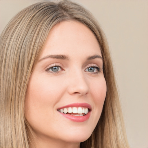 Joyful white young-adult female with long  brown hair and grey eyes