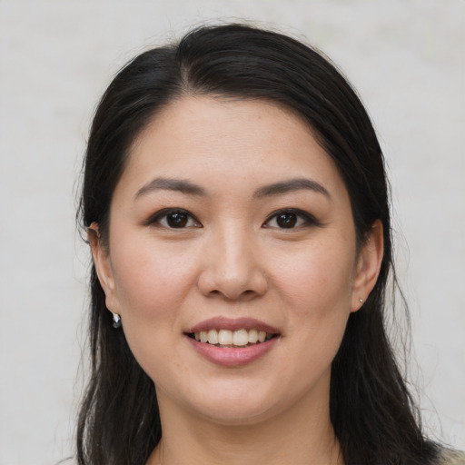 Joyful white young-adult female with long  black hair and brown eyes